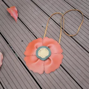 Cute flower-shaped children's crossbody bag with soft lychee texture on wooden floor