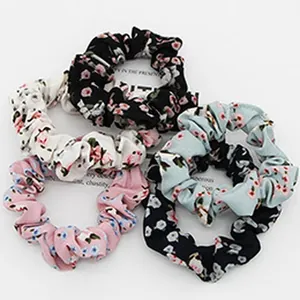 Detailed view of floral print hair scrunchies in various colors and stylish patterns.
