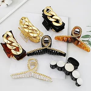 Group shot of stylish hair claw clips featuring chunky gold chains and various patterns