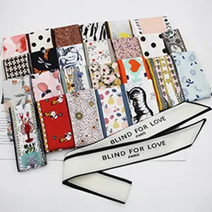 Detail view of various printed fabric hair ties including floral, polka dot, and houndstooth patterns