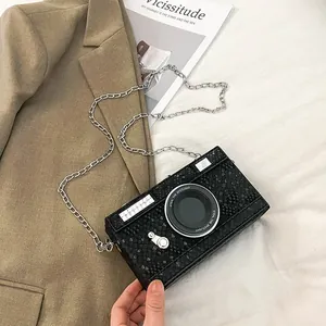 Vintage camera-shaped hard box crossbody bag with textured black finish and silver chain