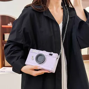 Detailed view of the purple crocodile texture camera shaped hard case crossbody bag