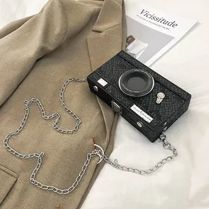 Unique vintage black camera-shaped box bag featuring chic snakeskin texture detail