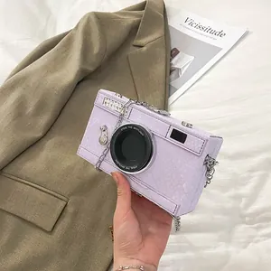 Detailed view of vintage purple camera-shaped box bag featuring a snakeskin texture