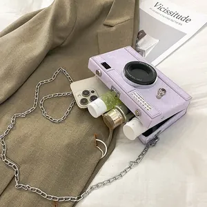 Detail view of an open purple camera-shaped hard box bag showing storage capacity