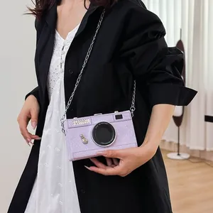 Detailed view of a stylish vintage camera-shaped hard box crossbody bag in textured purple