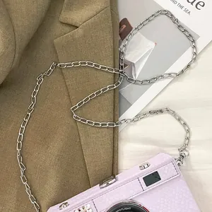 Close-up of lavender camera-style box bag with silver metal chain strap