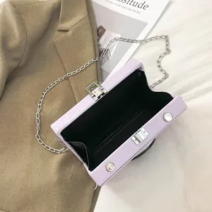 Vintage lavender camera-style hard shell box bag with a stylish silver chain strap