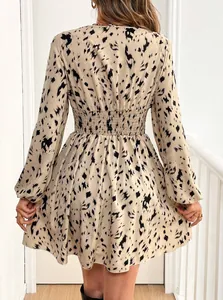 Detailed back view of a chic leopard print long-sleeve dress featuring a smocked waist