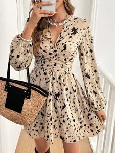 Stylish leopard print V-neck long sleeve dress with ruched waist and mini length detail.