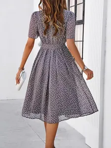 Detailed back view of an elegant grey polka dot midi dress featuring a belted waist design