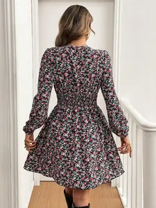 Back view of long-sleeved floral print dress with elastic waist and flared skirt