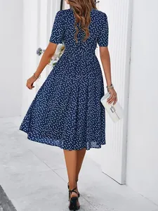 Back view of an elegant blue polka dot midi dress with short sleeves and waist tie.