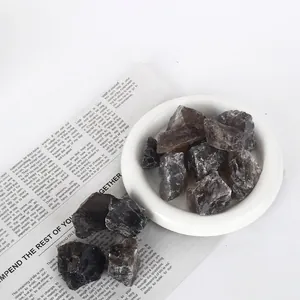 Natural raw smoky quartz crystal stones for aromatherapy diffuser in white dish.