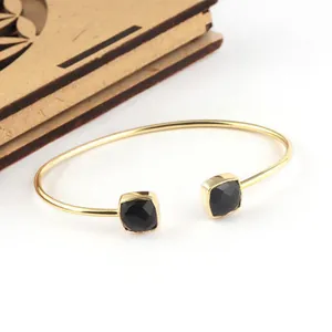 Modern gold stainless steel open bangle bracelet with square black stone embellishments