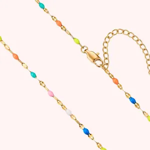 Close-up detail of rainbow enamel stainless steel necklace with gold lobster clasp closure