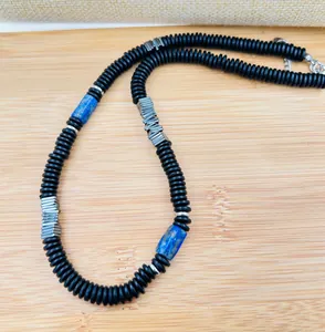 Detail view of natural coconut shell necklace with lapis lazuli and copper alloy beads
