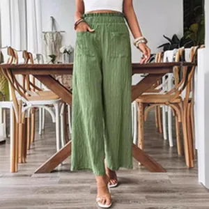 Detailed view of stylish women's high-waisted green wide-leg pants with elastic waist.