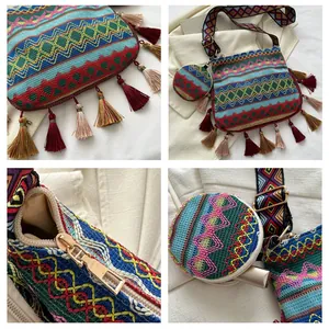 Detailed view of bohemian embroidered shoulder bag with tassels and matching small pouch