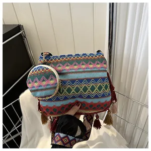 Close-up of ethnic woven crossbody bag with colorful patterns and matching mini pouch