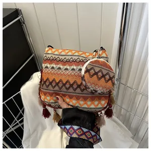 Detailed view of an ethnic woven crossbody bag with colorful patterns and tassels.