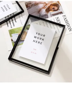 Minimalist black metal glass photo frame 15x20cm elegantly displayed on fashion magazines