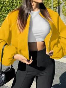 Close-up detail showing the soft texture of a yellow cropped bomber jacket for women