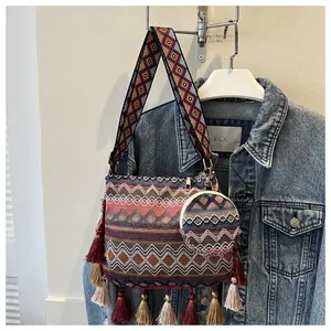 Detailed view of bohemian woven shoulder bag with colorful tassels and matching pouch