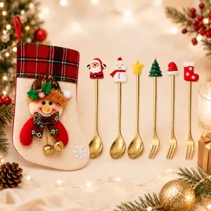 Detail shot of Christmas gold cutlery set including spoons, forks and a themed gift stocking