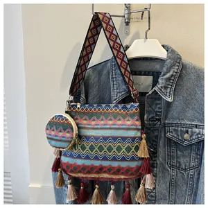 Detailed view of ethnic woven shoulder bag with tassels and matching coin pouch