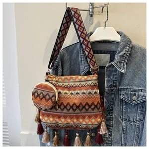 Detailed view of bohemian style shoulder bag with tassels and matching small coin purse