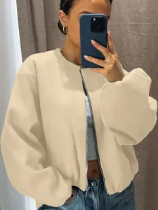 Detailed view of a soft apricot oversized bomber jacket with a silver metal zipper for women
