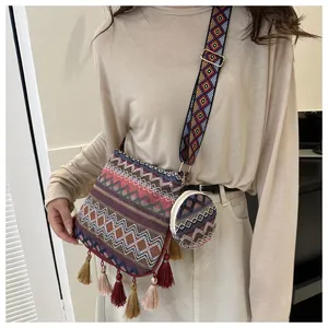 Ethnic style crossbody bag with colorful tassels and matching mini pouch on model