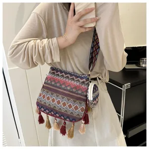 Bohemian ethnic style crossbody bag with tassels and matching small round pouch.