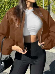 Detail of women's soft brown bomber jacket with zip closure and ribbed cuffs
