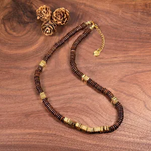 Detail view of natural coconut shell and copper alloy beaded necklace with golden spacers