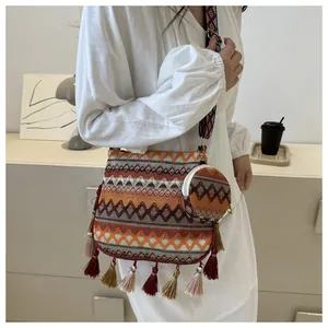 Ethnic style woven crossbody bag with colorful tassels and matching mini coin purse detail