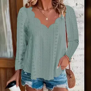 Detail view of the scalloped neckline and breathable jacquard fabric of this blouse.