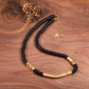 Detailed view of the natural coconut shell and gold-tone alloy beaded necklace