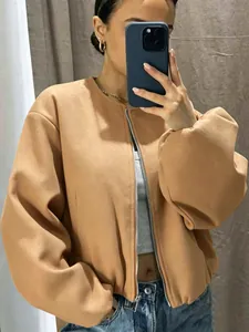 Close-up of camel-colored soft bomber jacket with silver zipper detail