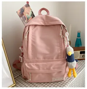 Close-up of a pink high-capacity school backpack with a cute plush duck pendant