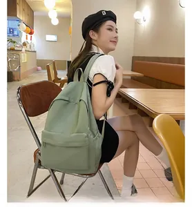 Nahaufnahme eines minimalistischen salbeigrünen Rucksacks, getragen von einem Model