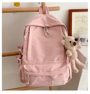Detailed view of the pink Korean style backpack with cute teddy bear keychain