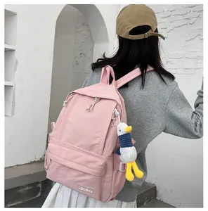 Back view of a pink Korean style schoolbag for girls featuring a cute duck plush charm