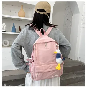 Detail view of a pink Mori style large capacity school backpack with a cute duck charm