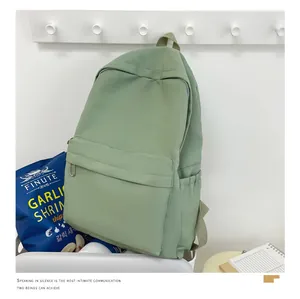 Minimalistischer salbeigrüner Nylon-Rucksack für Studenten in sauberer Lifestyle-Umgebung.