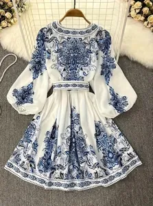 Detailed view of bohemian style long-sleeved dress with elegant blue paisley prints