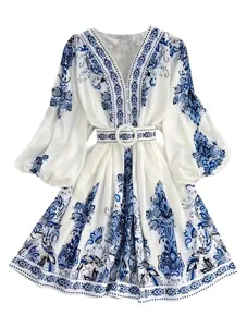 Detailed view of Bohemian V-neck long sleeve dress with blue floral print and belt.
