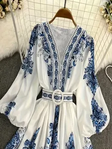 Detail of a bohemian floral print V-neck dress with matching belt for spring 2025 fashion