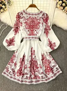 Detailed view of white bohemian print long-sleeve dress with matching belt